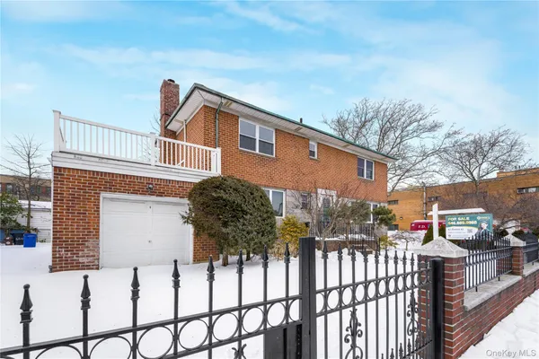 a view of a house with wooden fence