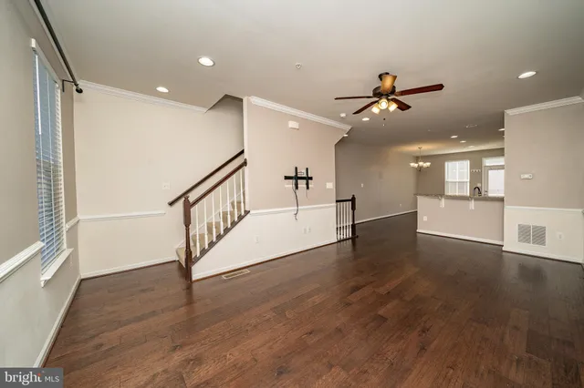 a view of a room with wooden floor and white walls