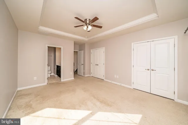 a view of an empty room with a ceiling fan