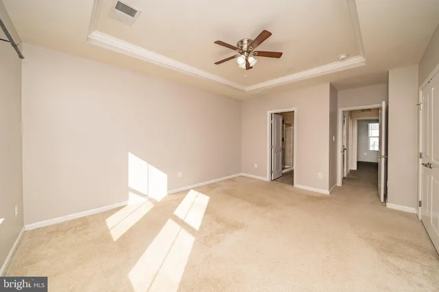 a view of a big room with wooden floor and a chandelier fan