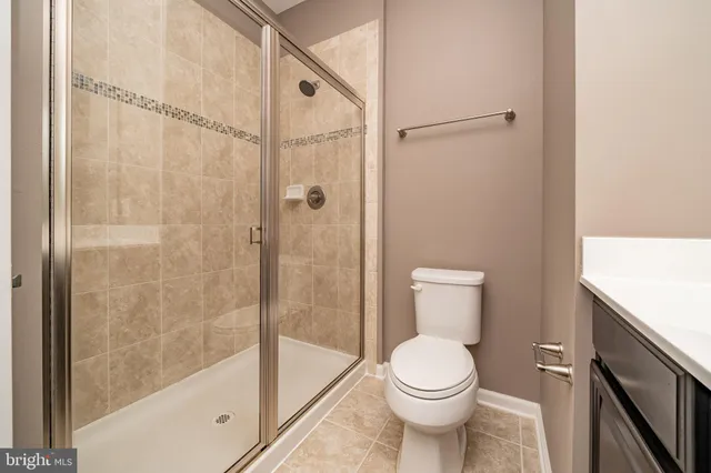 a bathroom with a toilet and shower