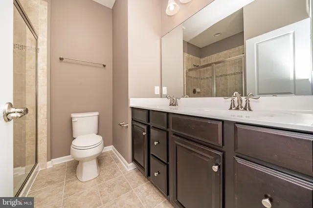 a bathroom with a sink toilet and a mirror
