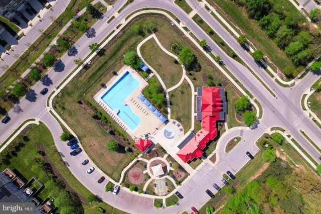 an aerial view of residential houses with outdoor space and swimming pool