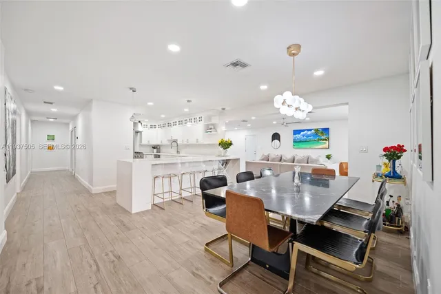a view of a dining room with furniture and wooden floor