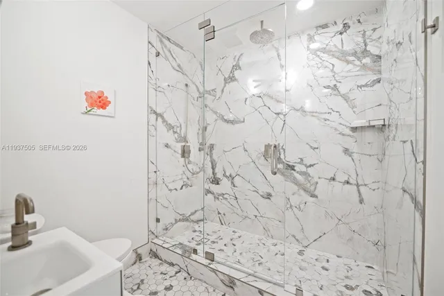 a bathroom with a shower and a sink