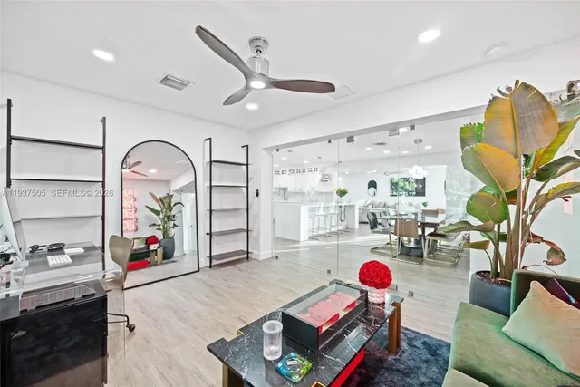 a living room with furniture and wooden floor