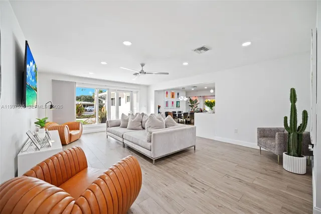 a living room with furniture and wooden floor