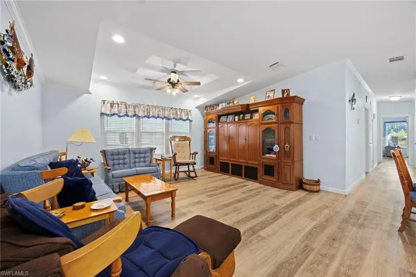 a living room with furniture a ceiling fan and a rug