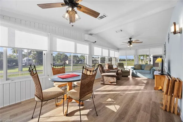 a living room with furniture and floor to ceiling window