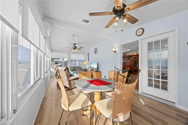 a view of a dining room with furniture window and wooden floor