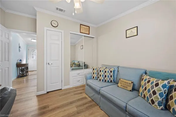 a bedroom with furniture and a wooden floor