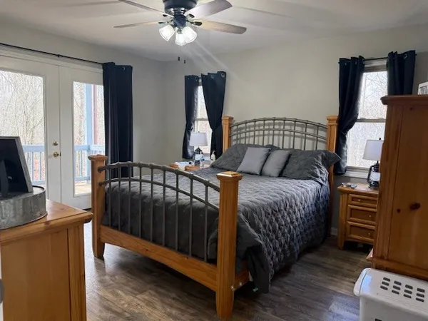 a bedroom with bed and wooden floor
