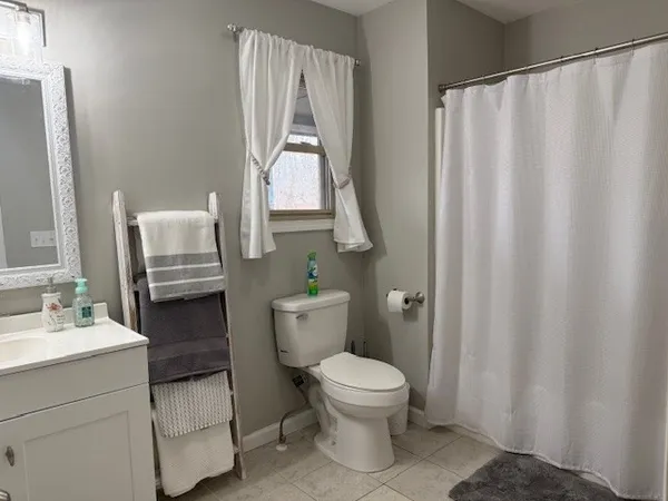 a bathroom with a sink a toilet and a mirror