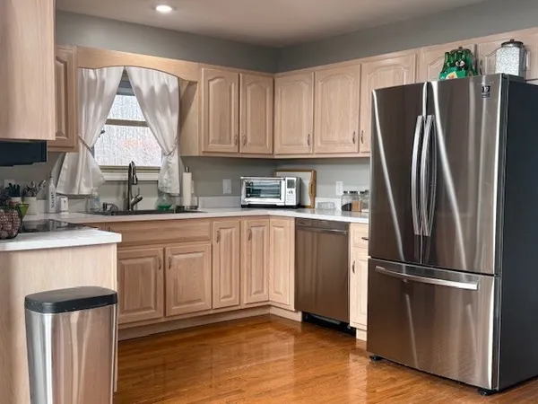 a kitchen with stainless steel appliances a refrigerator sink and cabinets