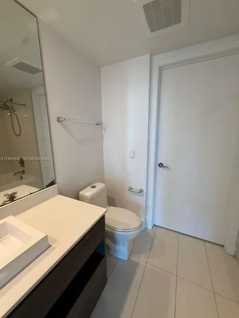 a en suite bathroom with a double vanity sink and a mirror