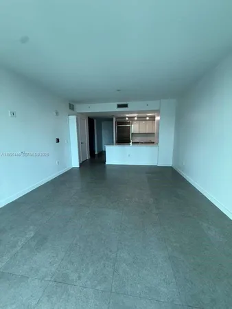 an empty room with wooden floor and closet