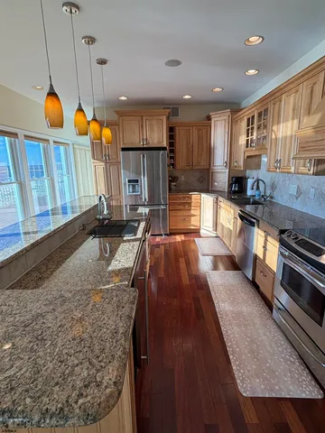 a bedroom with a bed and a lamp on dresser