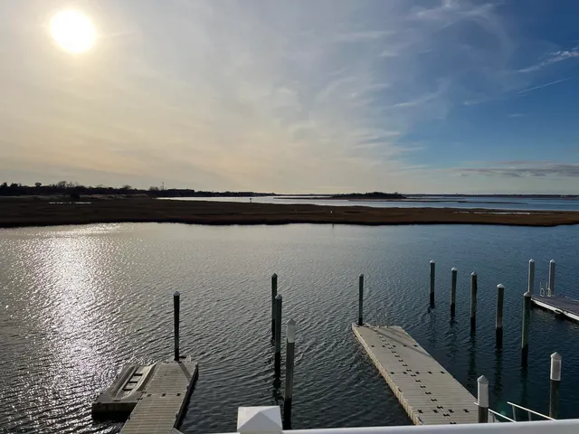 a kitchen with kitchen island granite countertop a sink a counter top space appliances and cabinets