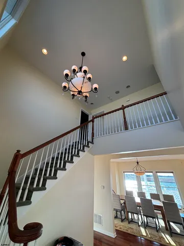 a living room with furniture flat screen tv and a large window