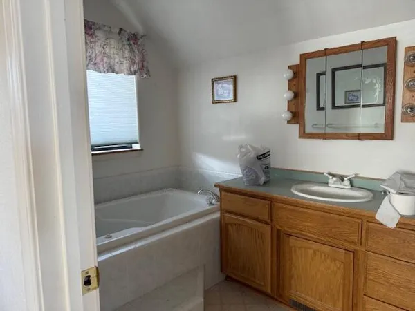 a bathroom with a granite countertop sink a toilet and mirror