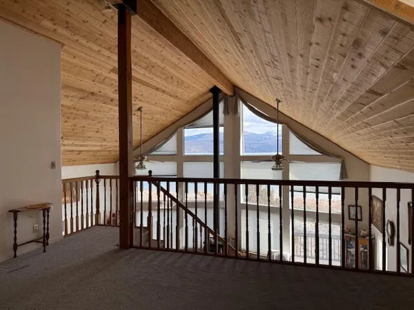 a view of staircase with railing and white walls