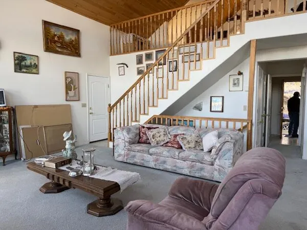 a living room with furniture and stairs