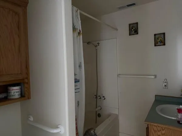 a bathroom with a sink and glass door