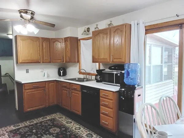 a kitchen with stainless steel appliances granite countertop a sink stove and cabinets