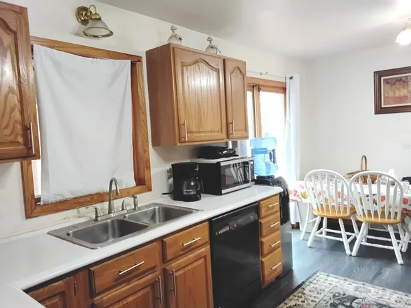 a kitchen with a sink cabinets and window