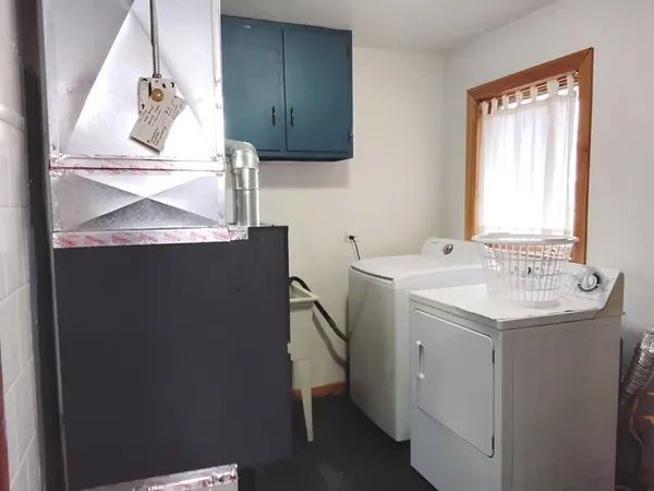 a utility room with a sink washer and dryer