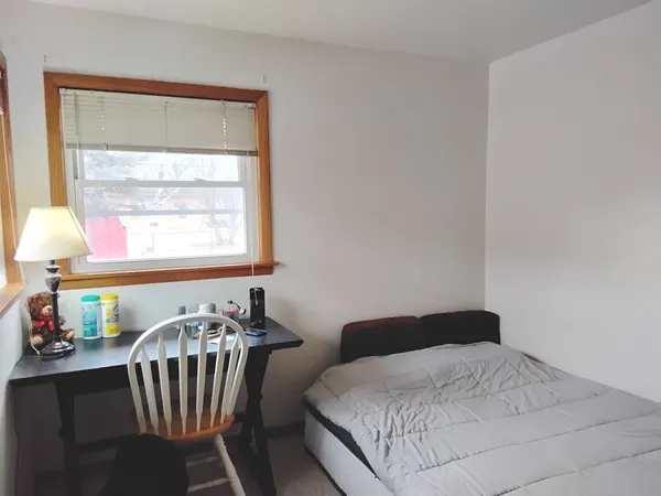 a bedroom with a bed and a window