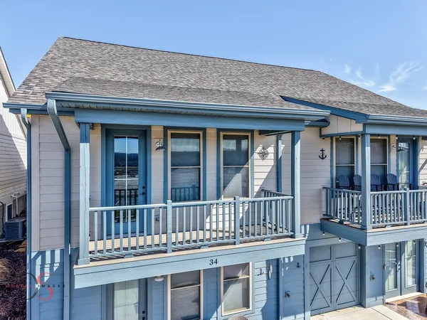 a view of a brick house with large windows