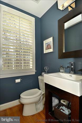 2801 Rifle Ridge Road Oakton, VA 22124 - Photo 17 of 30 a bathroom with a toilet a sink and a window