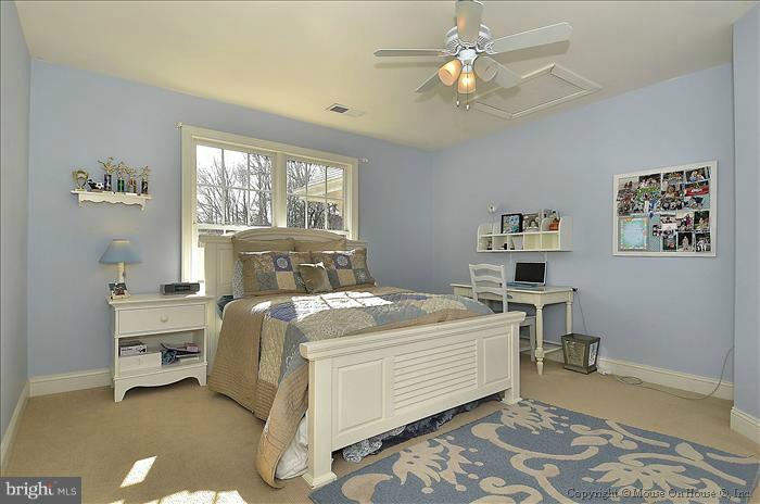 2801 Rifle Ridge Road Oakton, VA 22124 - Photo 19 of 30 a bed room with a bed and a chandelier