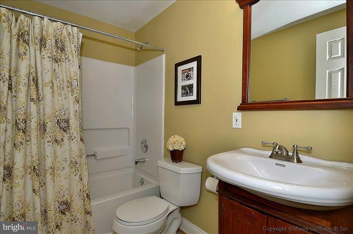 2801 Rifle Ridge Road Oakton, VA 22124 - Photo 20 of 30 a bathroom with a sink a toilet and shower curtain