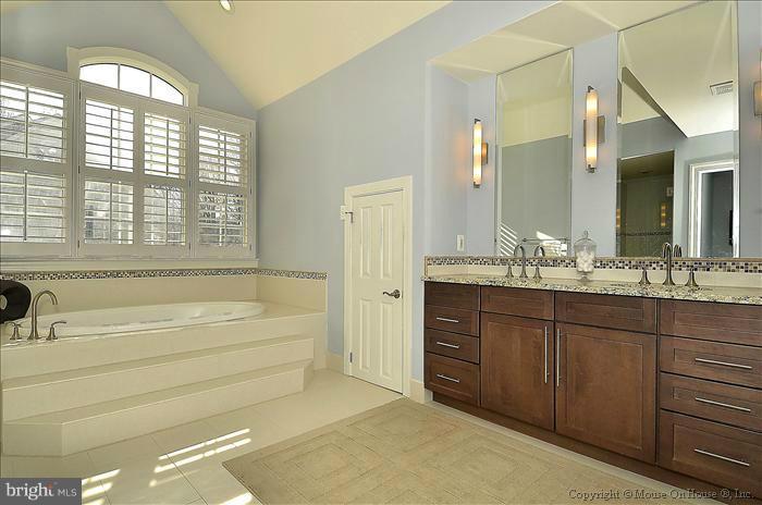 2801 Rifle Ridge Road Oakton, VA 22124 - Photo 23 of 30 a spacious bathroom with a tub sink and mirror