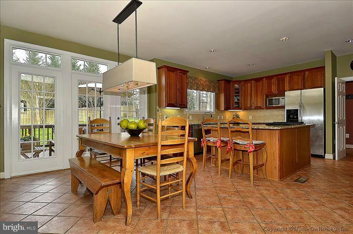 2801 Rifle Ridge Road Oakton, VA 22124 - Photo 25 of 30 a dining table chairs and a kitchen view