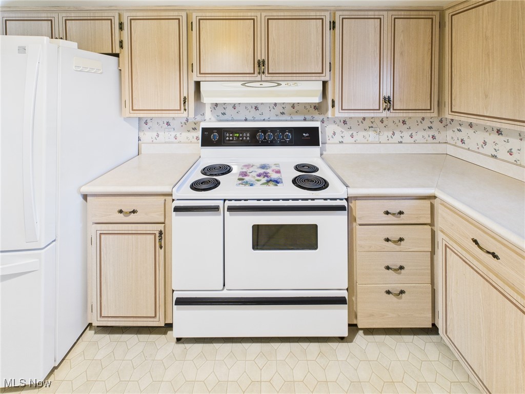 207 Stone Oak Road Davisville, WV 26142 - Photo 5 of 22 Kitchen featuring light brown cabinets, white appliances, light countertops, light tile patterned floors, and under cabinet range hood
