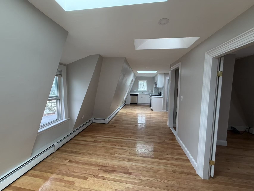 6 Channing Street, Unit 3 Newton, MA 02458 - Photo 11 of 12 a view of a hallway view with wooden floor and staircase