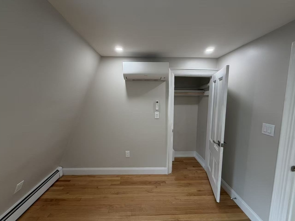 6 Channing Street, Unit 3 Newton, MA 02458 - Photo 6 of 12 an empty room with wooden floor and entrance
