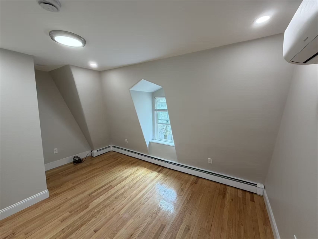 6 Channing Street, Unit 3 Newton, MA 02458 - Photo 7 of 12 a view of room with window and wooden floor
