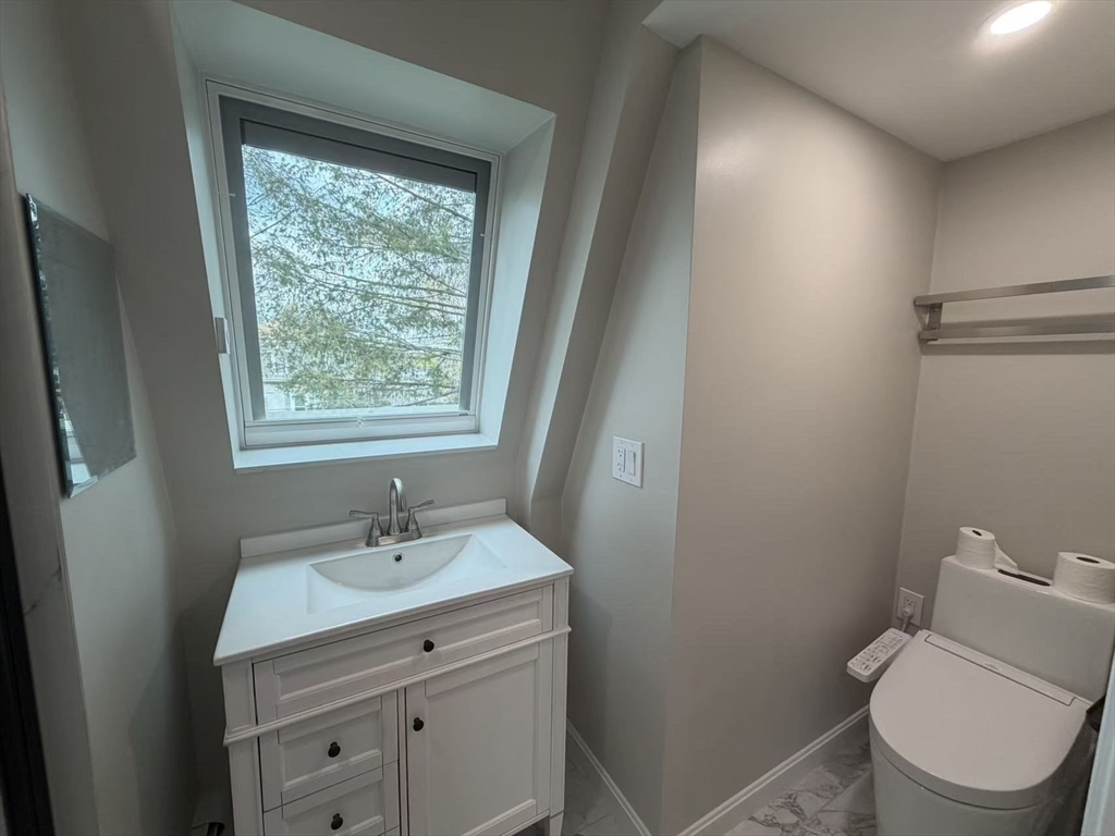 6 Channing Street, Unit 3 Newton, MA 02458 - Photo 8 of 12 a bathroom with a toilet a sink a vanity and mirror