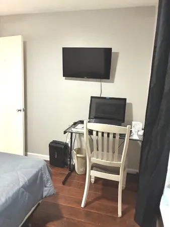 a bedroom with a bed and a flat screen tv