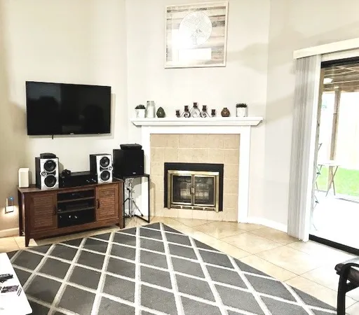 a living room with a fireplace and a flat screen tv