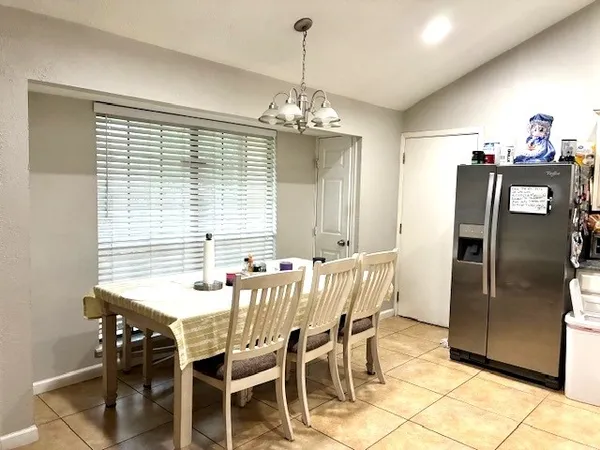a view of a dining room with furniture window and chandelier