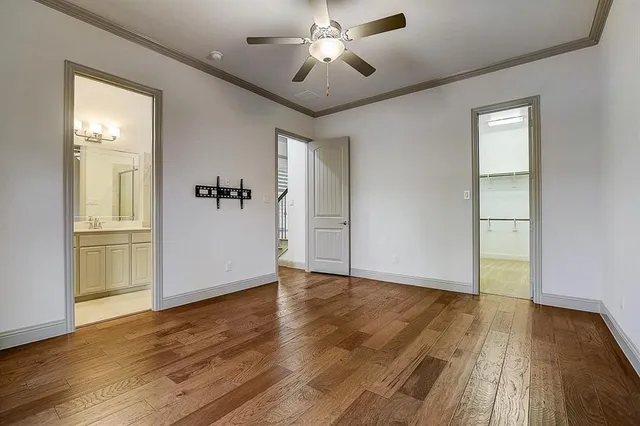 a view of a livingroom with wooden floor and a ceiling fan