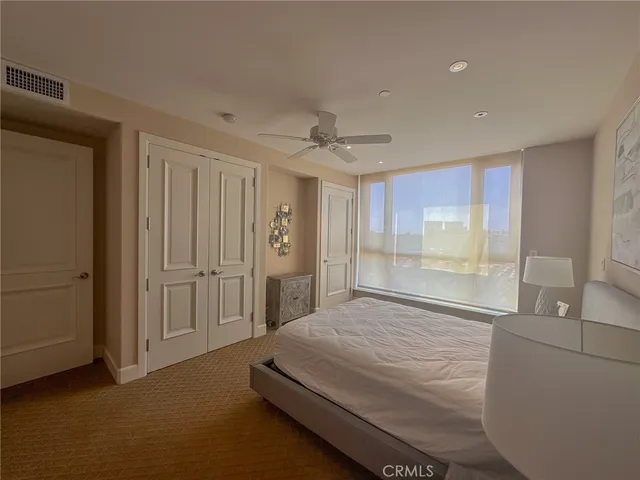 a living room with furniture a lamp and a potted plant