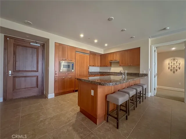 a kitchen with stainless steel appliances granite countertop sink and wooden cabinets