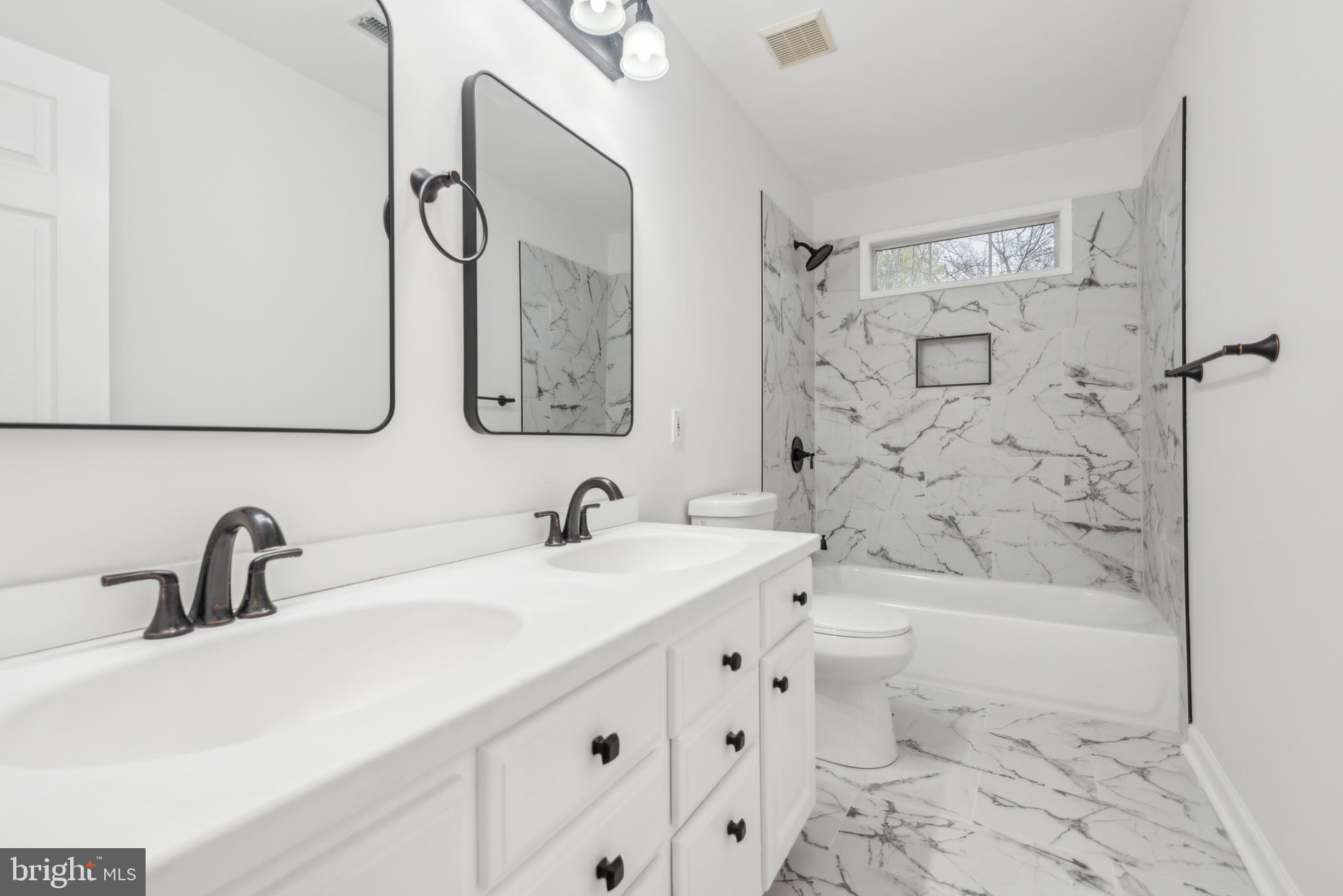 1825 Johnson Road Annapolis, MD 21409 - Photo 27 of 44 a bathroom with a sink a toilet and shower
