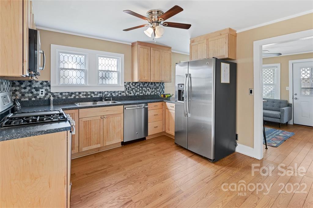 60 Shiloh Road Asheville, NC 28803 - Photo 5 of 13 a kitchen with stainless steel appliances granite countertop a stove a refrigerator and a sink